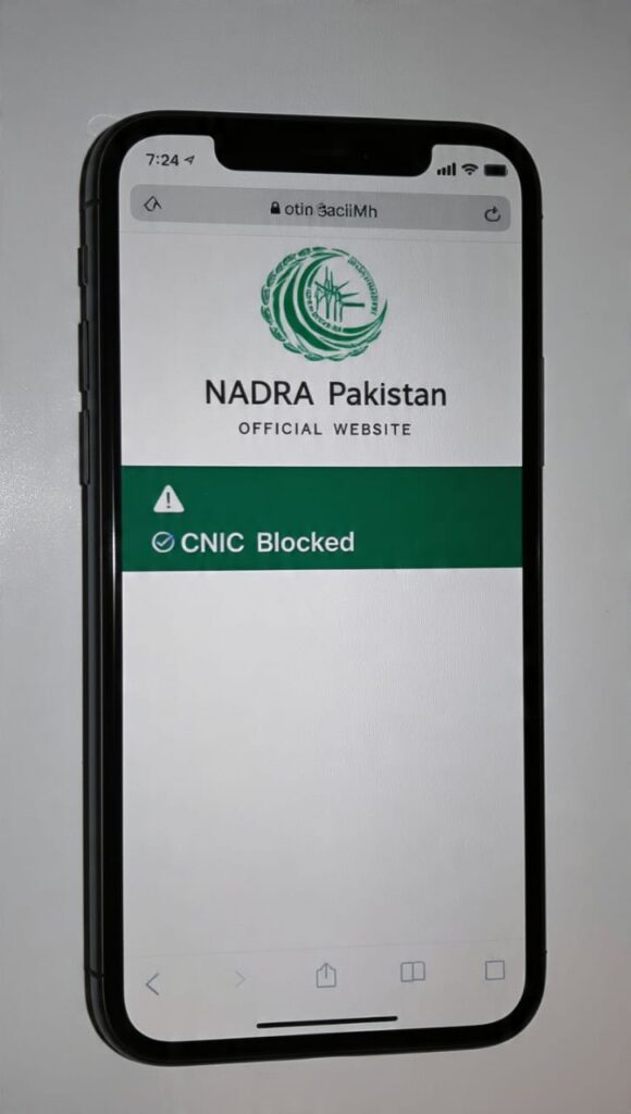NADRA CNIC Blocked Status 2026 - Mobile showing blocked CNIC error and NADRA website in background